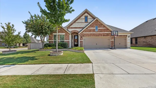 a front view of a house with a yard and garage