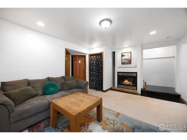 a living room with furniture a walk in closet and a window