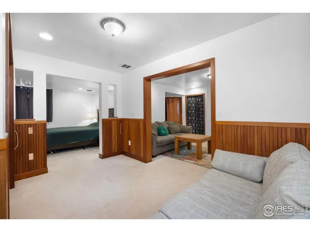 a bedroom with a bed and a lamp