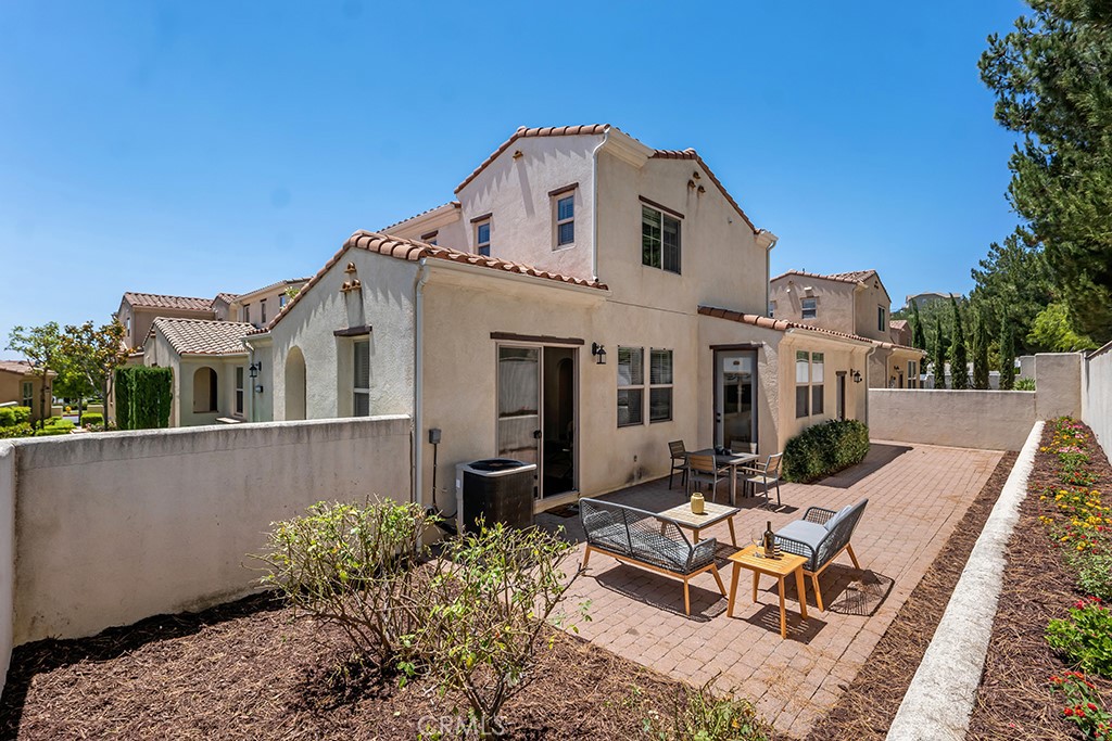 20317 Livorno Porter Ranch Porter Ranch, CA 91326 - Photo 24 of 33 a view of a white house with a yard and furniture