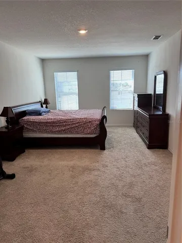 a bedroom with furniture and window