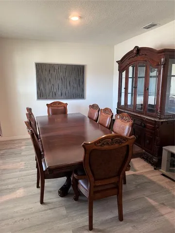 a view of a dining room with furniture and chandelier