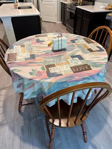 a kitchen with a table chairs and wooden floor