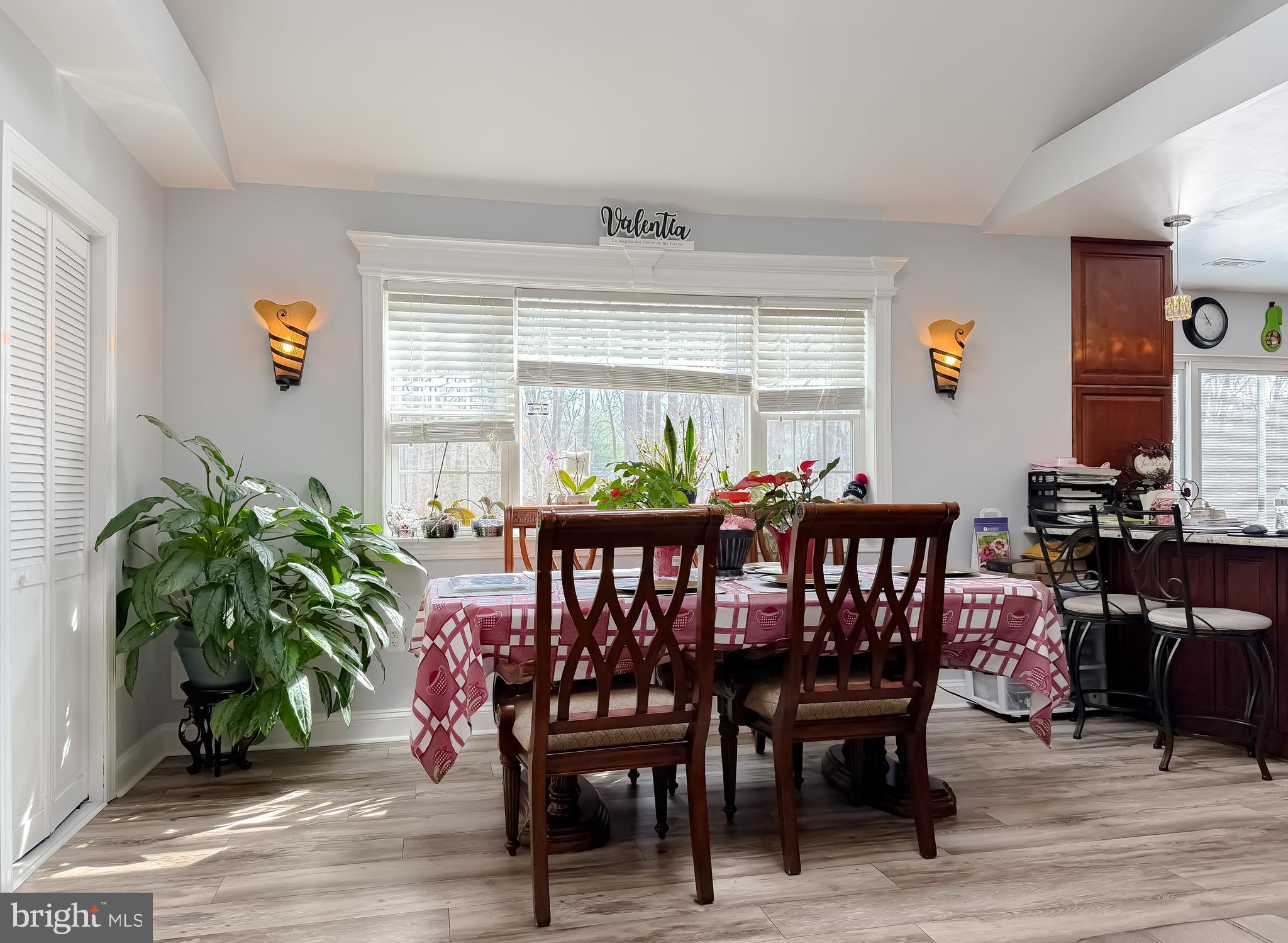 30150 Huntt Road Mechanicsville, MD 20659 - Photo 14 of 40 a dining room with furniture potted plants and wooden floor