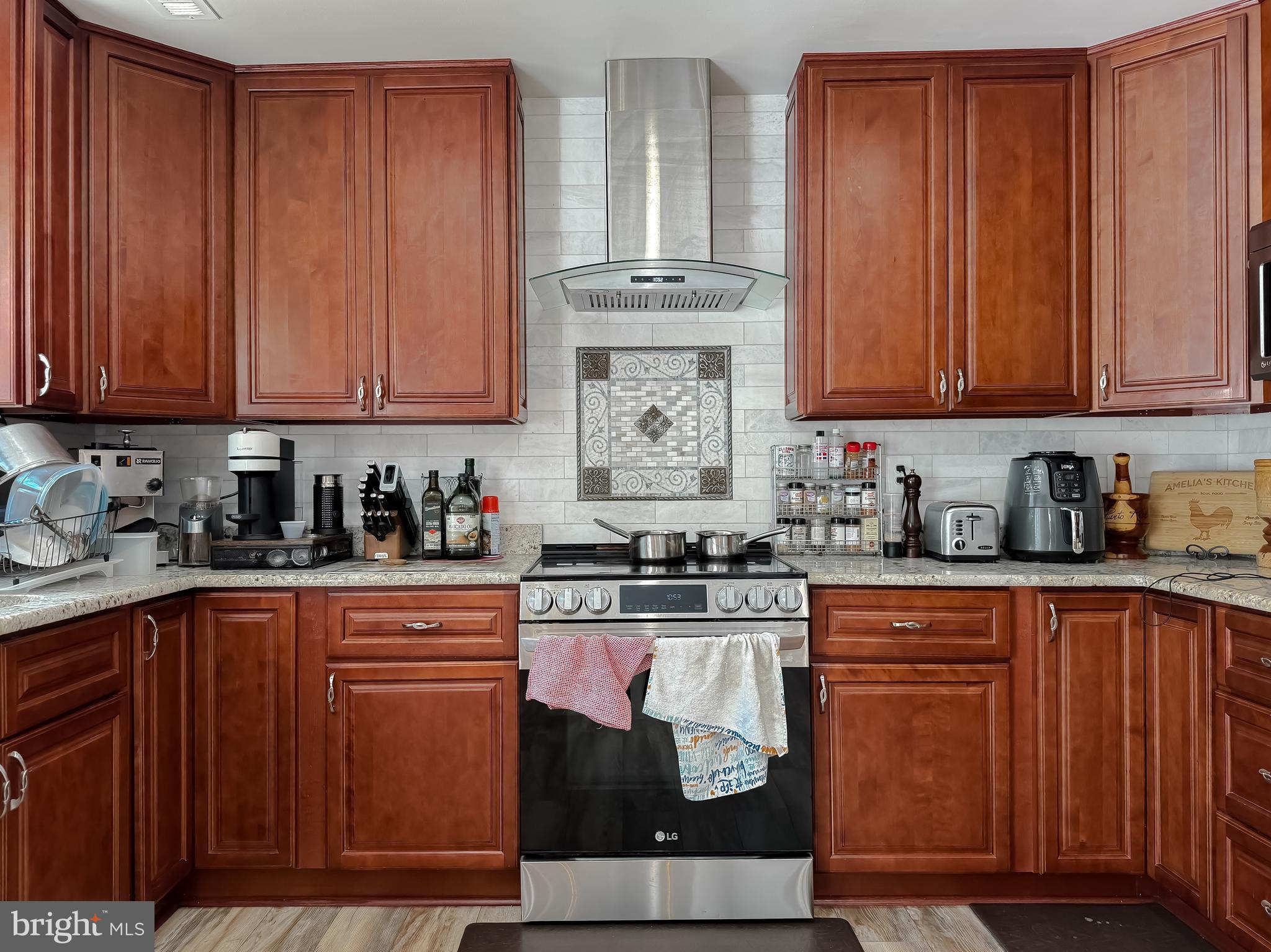 30150 Huntt Road Mechanicsville, MD 20659 - Photo 17 of 40 a kitchen with stainless steel appliances granite countertop wooden cabinets a sink and dishwasher