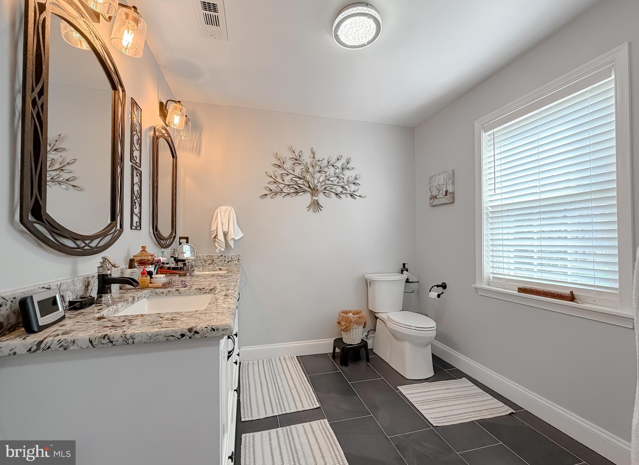 30150 Huntt Road Mechanicsville, MD 20659 - Photo 26 of 40 a bathroom with a sink and a mirror