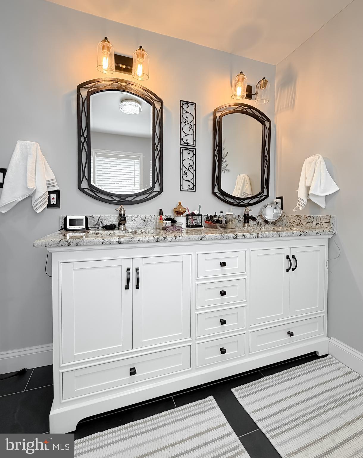 30150 Huntt Road Mechanicsville, MD 20659 - Photo 27 of 40 a bathroom with double vanity white cabinets and a mirror