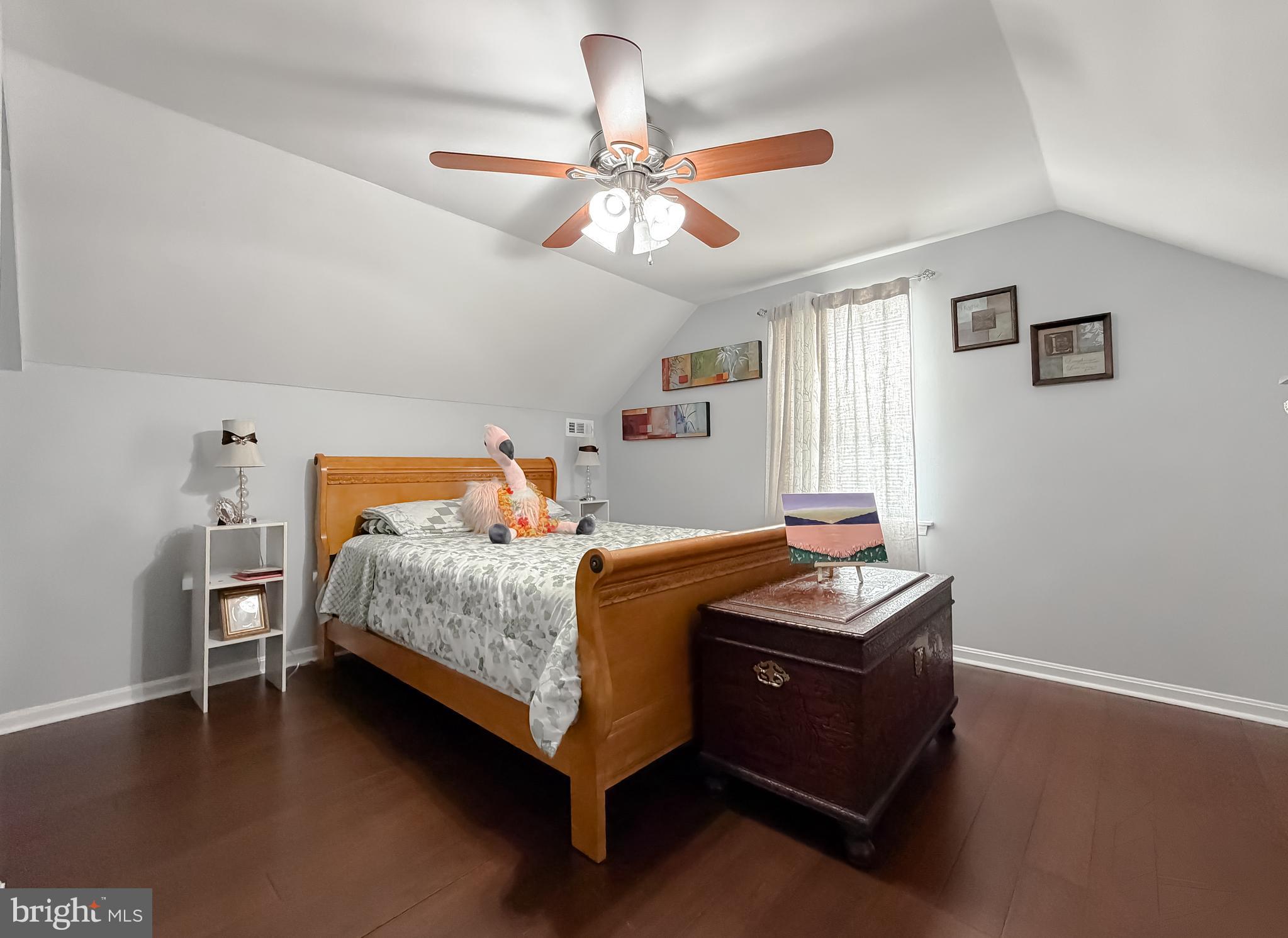 30150 Huntt Road Mechanicsville, MD 20659 - Photo 29 of 40 a bedroom with a bed and a chandelier