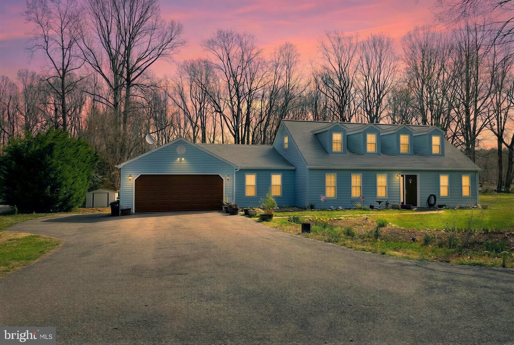30150 Huntt Road Mechanicsville, MD 20659 - Photo 3 of 40 a front view of a house with a yard and garage