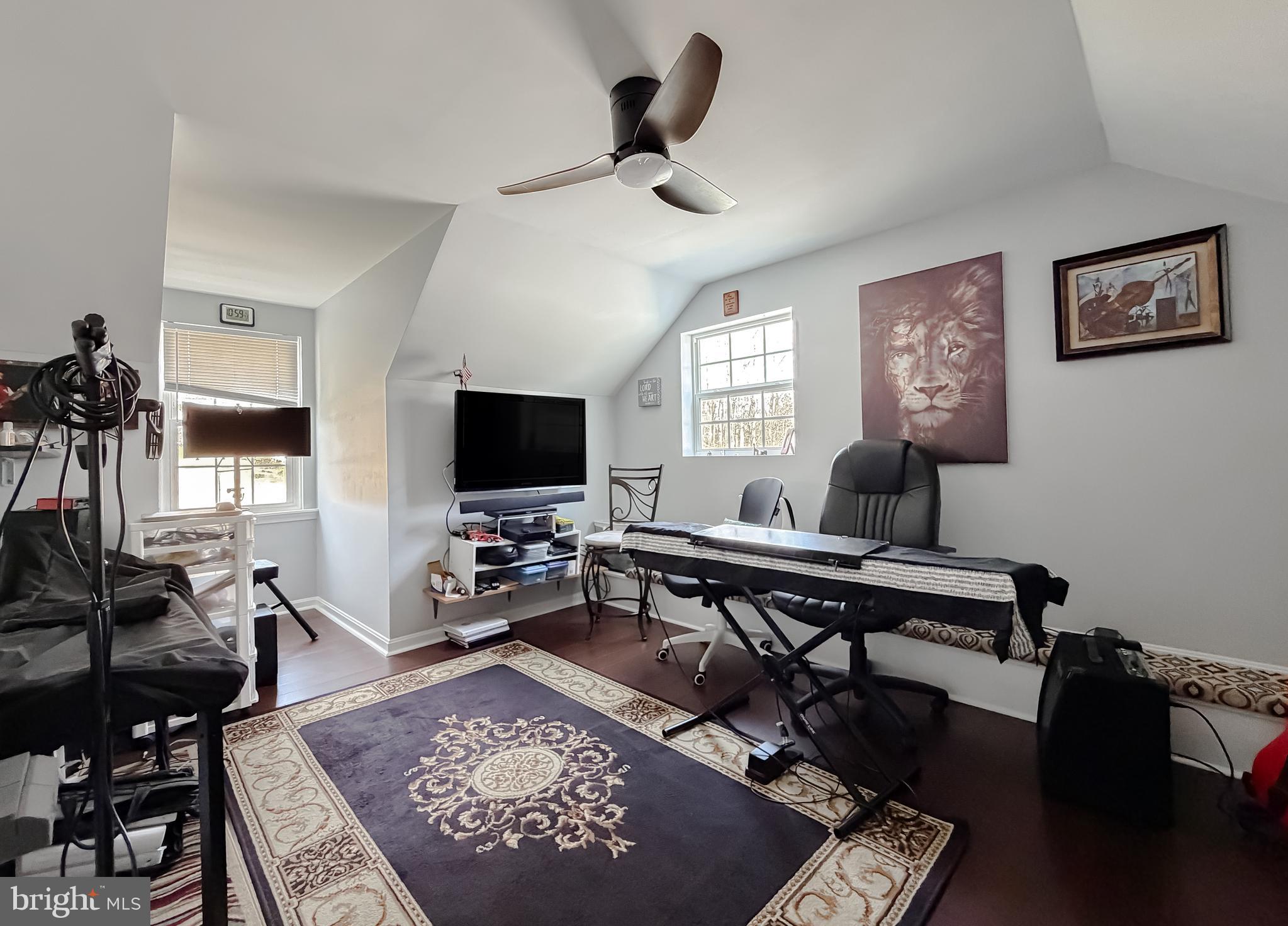 30150 Huntt Road Mechanicsville, MD 20659 - Photo 35 of 40 a living room with furniture a rug and a flat screen tv