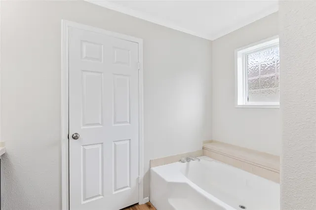 a white bath tub sitting in a bathroom