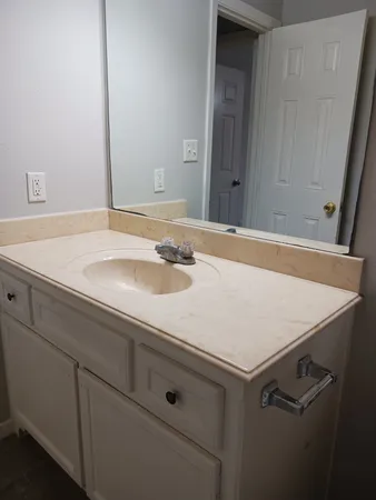a bathroom with a sink and a mirror