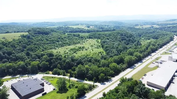 an aerial view of a house with a yard and lake view