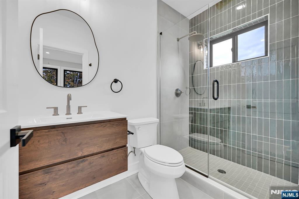 28 Bennington Road Livingston, NJ 07039 - Photo 19 of 38 a bathroom with a sink a toilet and a mirror