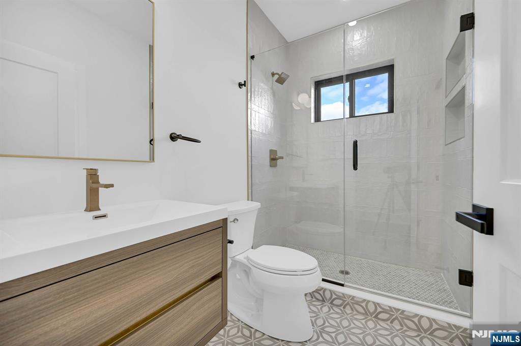 28 Bennington Road Livingston, NJ 07039 - Photo 20 of 38 a bathroom with a sink a toilet and shower