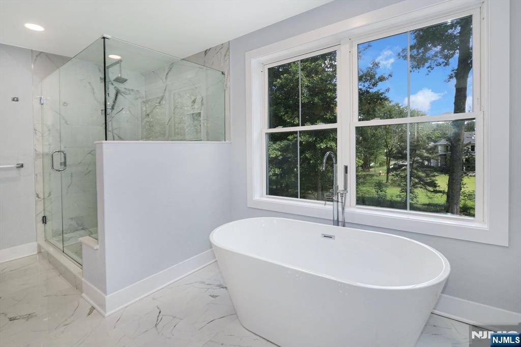 28 Bennington Road Livingston, NJ 07039 - Photo 27 of 38 a white bath tub sitting next to a bathroom