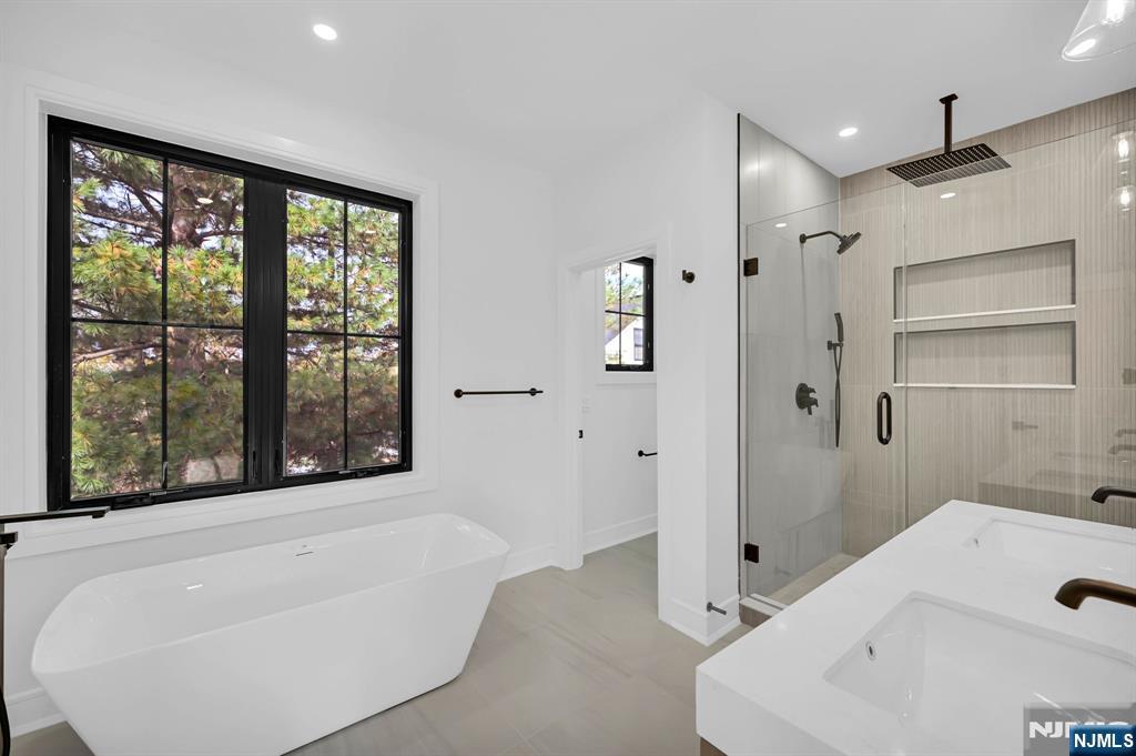 28 Bennington Road Livingston, NJ 07039 - Photo 29 of 38 a bathroom with a bathtub and a shower