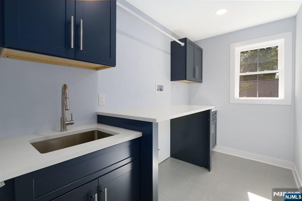 28 Bennington Road Livingston, NJ 07039 - Photo 32 of 38 a kitchen with a sink and a mirror