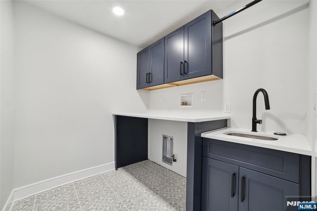 28 Bennington Road Livingston, NJ 07039 - Photo 34 of 38 a kitchen with a sink and a mirror