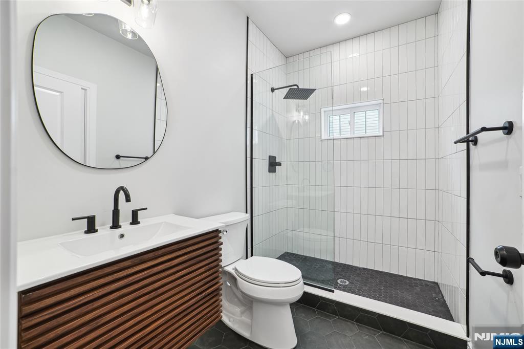 28 Bennington Road Livingston, NJ 07039 - Photo 35 of 38 a bathroom with a sink a toilet and shower