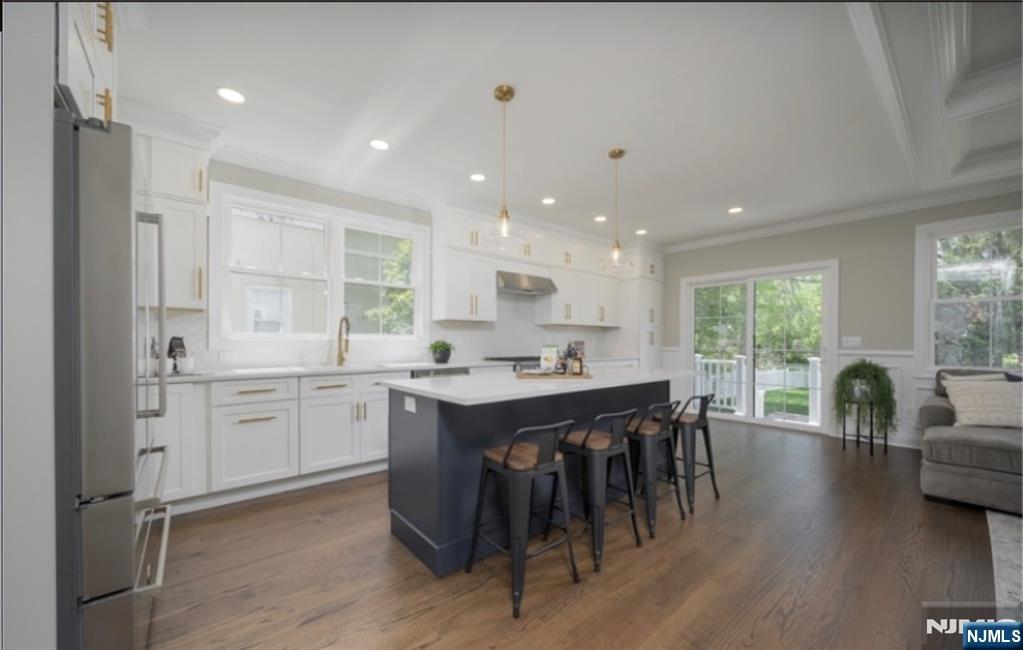 28 Bennington Road Livingston, NJ 07039 - Photo 6 of 38 a kitchen with kitchen island granite countertop a sink and chairs