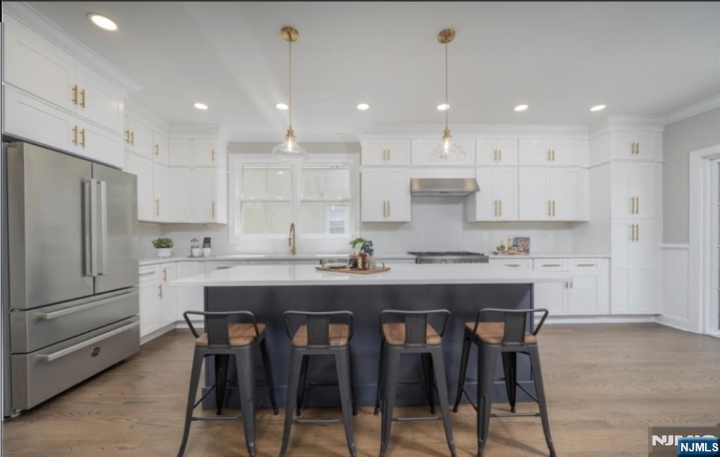 28 Bennington Road Livingston, NJ 07039 - Photo 7 of 38 a large kitchen with kitchen island a dining table and chairs