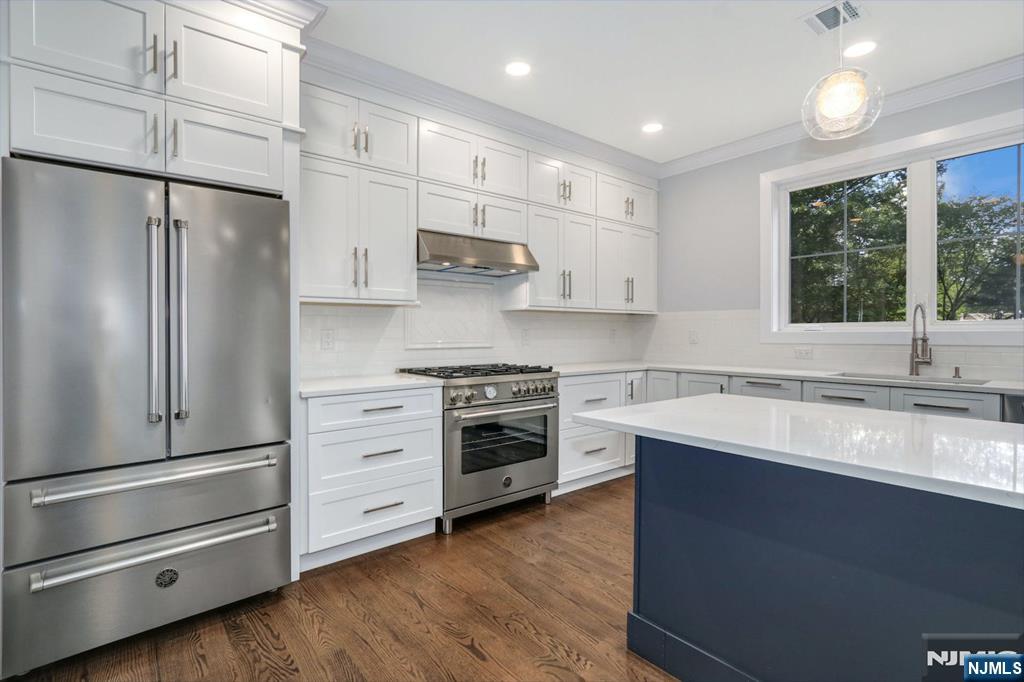 28 Bennington Road Livingston, NJ 07039 - Photo 8 of 38 a kitchen with stainless steel appliances white cabinets and a window