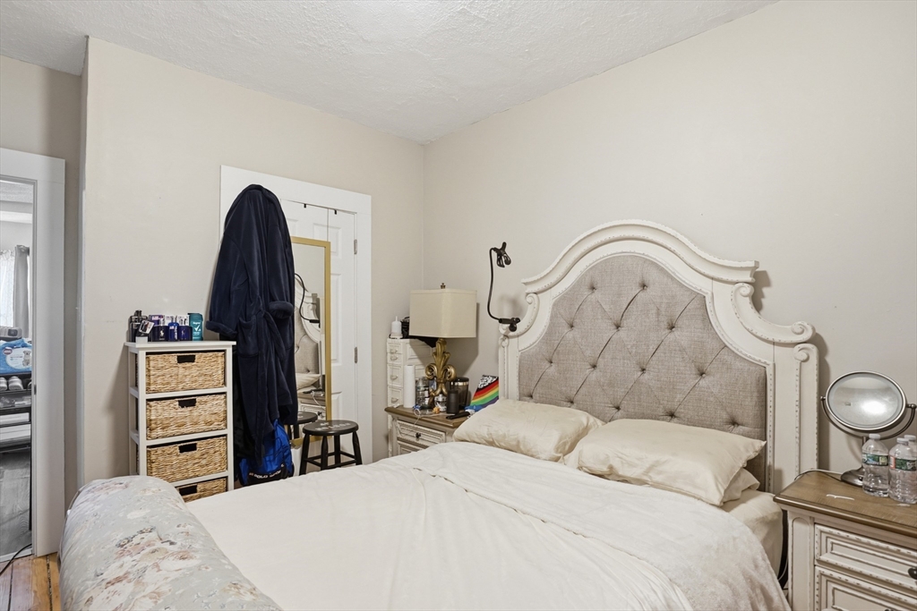 196 Irving Street Fall River, MA 02723 - Photo 29 of 34 a bedroom with a bed and a mirror