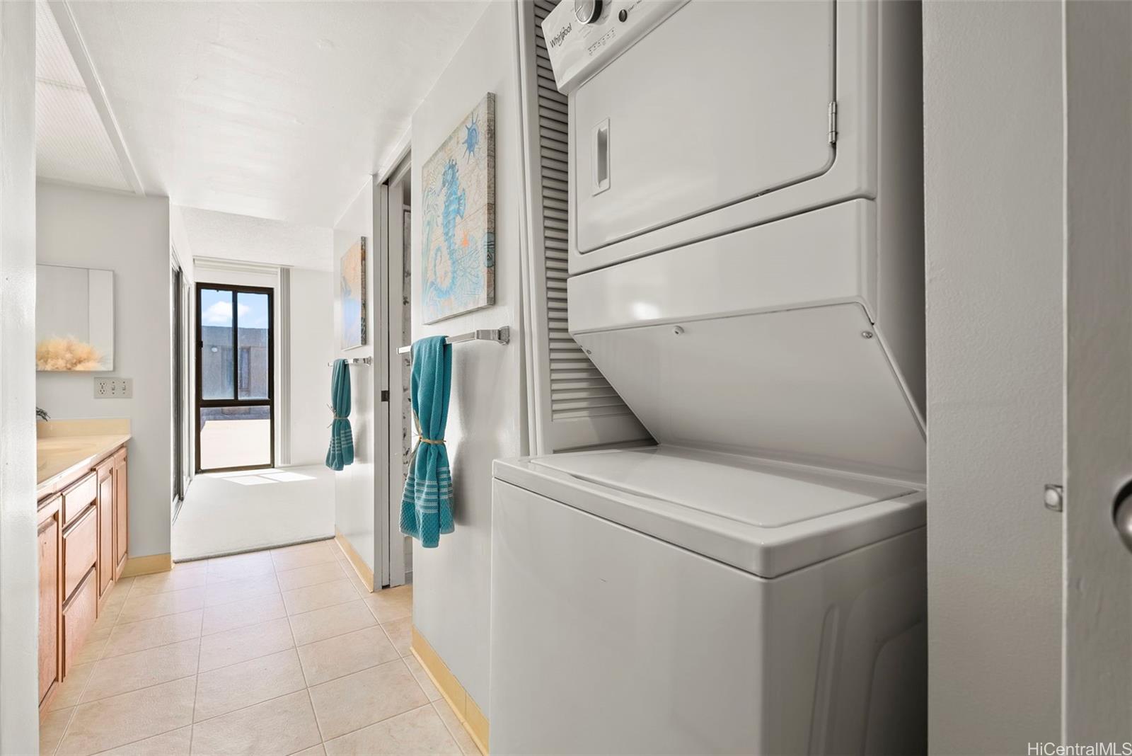 217 Prospect Street, Unit M10 Honolulu, HI 96813 - Photo 11 of 25 a view of washer and dryer with kitchen in the background