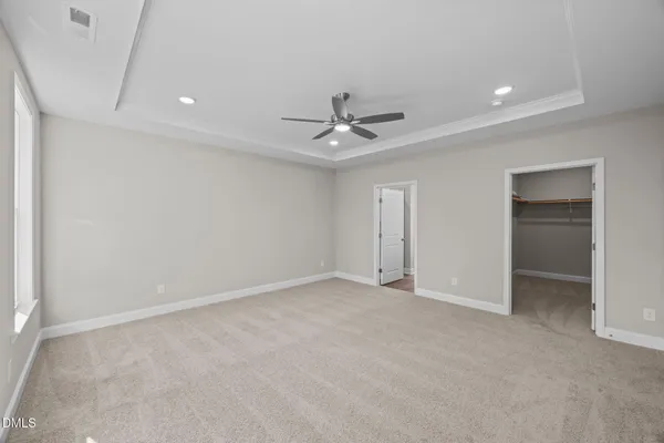a spacious bathroom with a double vanity sink a mirror and a shower