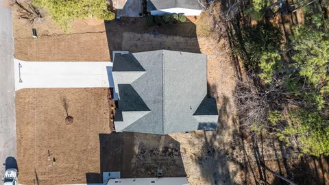 an aerial view of a house with a yard