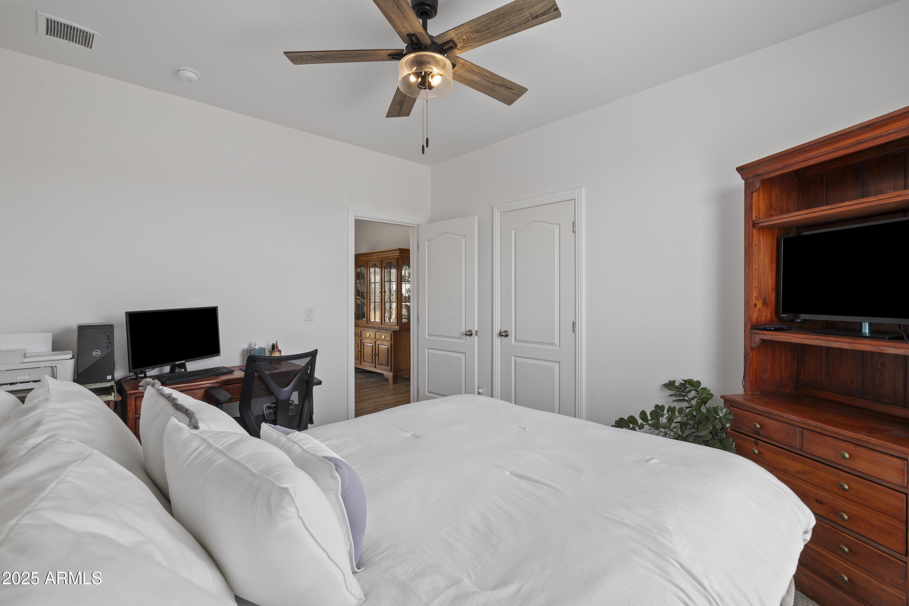 1235 North Harvest Road Dewey, AZ 86327 - Photo 16 of 37 a bedroom with a bed and a flat screen tv