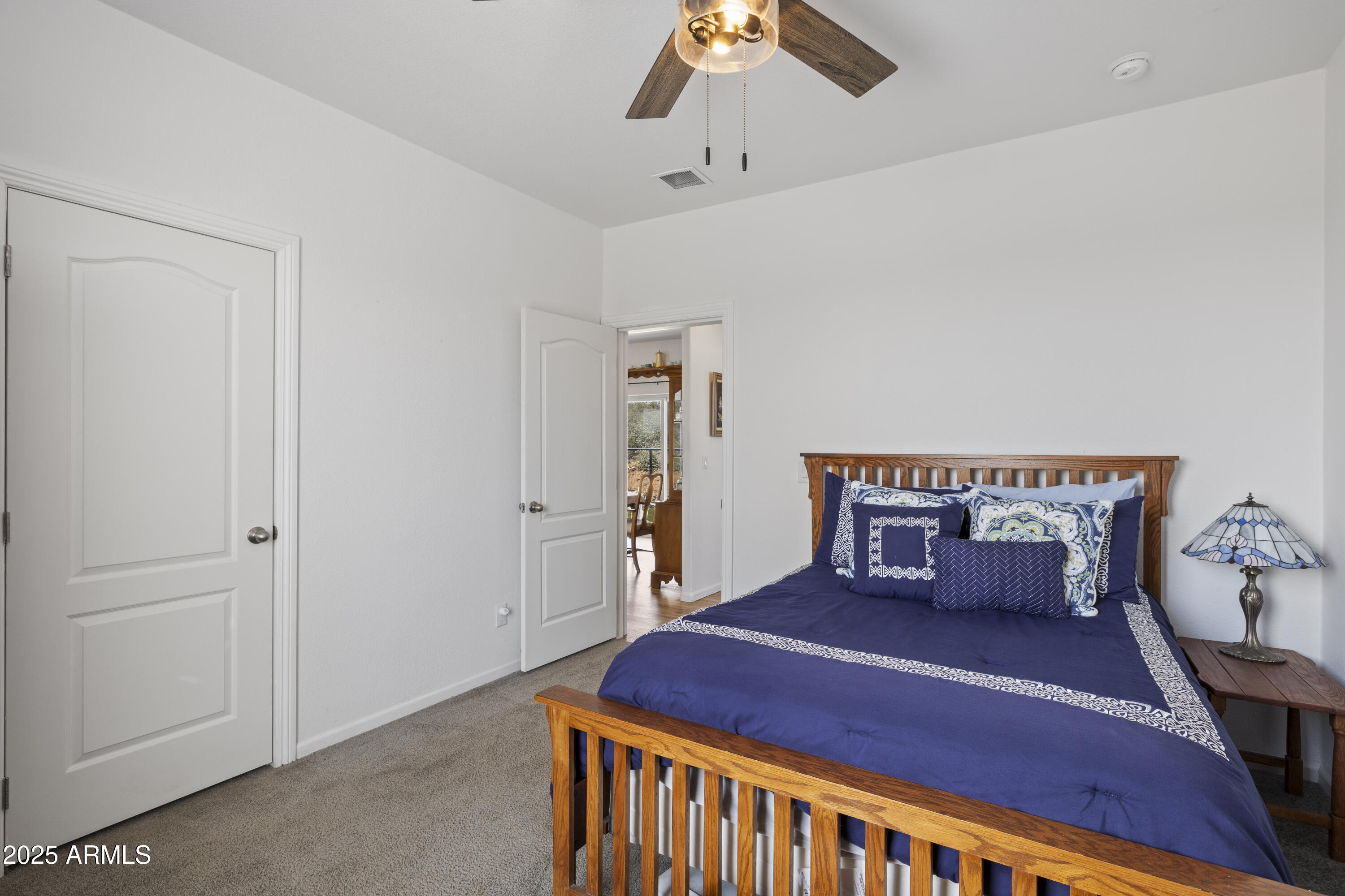 1235 North Harvest Road Dewey, AZ 86327 - Photo 18 of 37 a bedroom with a bed and a chandelier