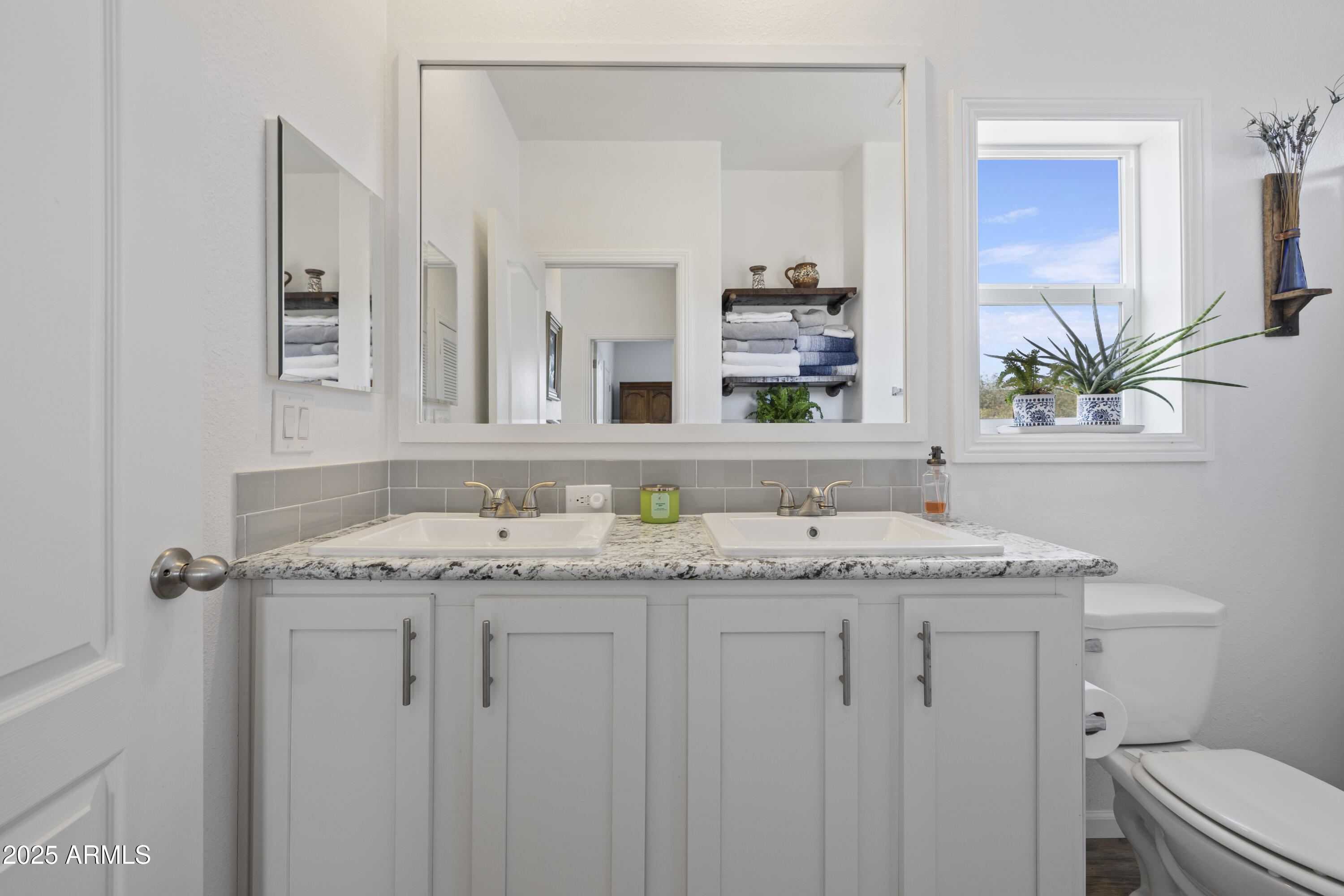 1235 North Harvest Road Dewey, AZ 86327 - Photo 19 of 37 a bathroom with a granite countertop sink and a mirror