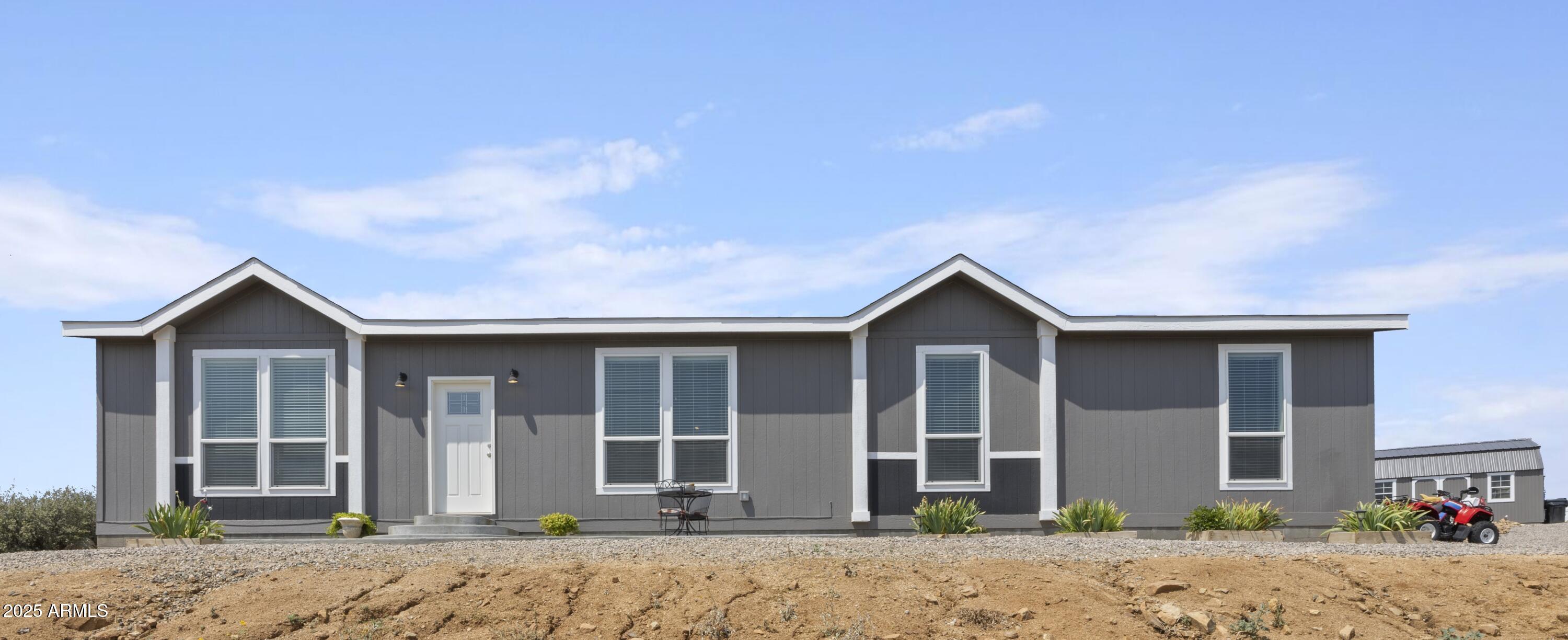 1235 North Harvest Road Dewey, AZ 86327 - Photo 27 of 37 a front view of a house with a yard