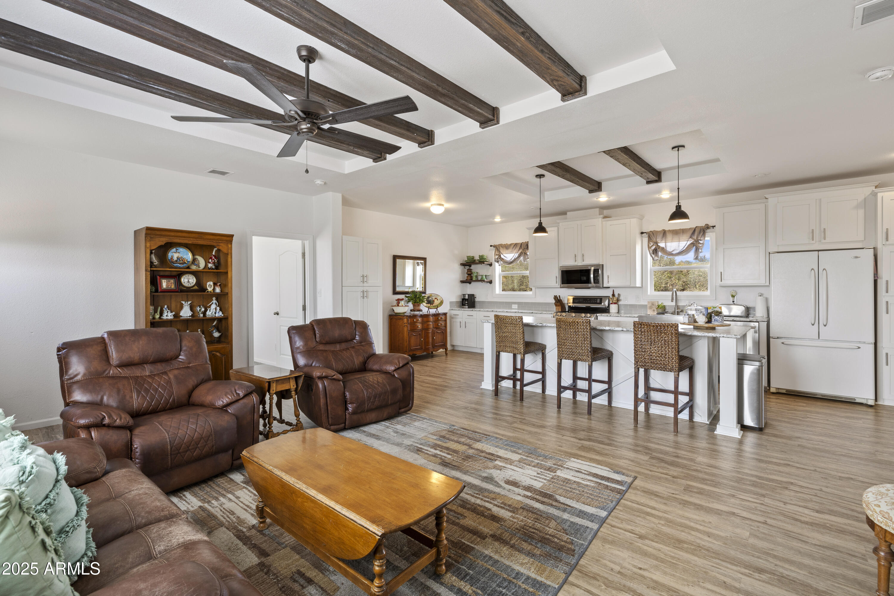 1235 North Harvest Road Dewey, AZ 86327 - Photo 4 of 37 a living room with furniture kitchen view and a wooden floor
