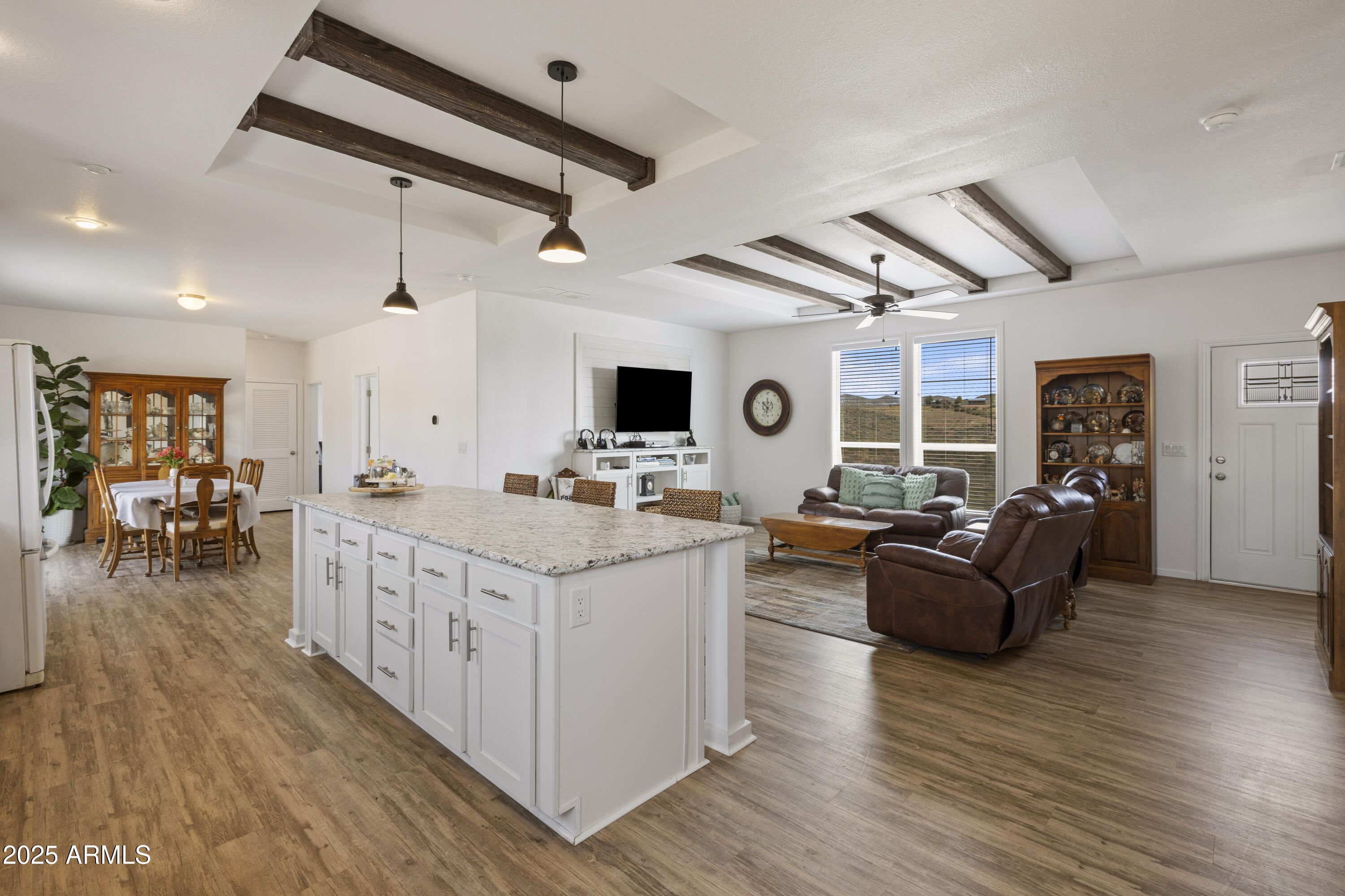 1235 North Harvest Road Dewey, AZ 86327 - Photo 7 of 37 a large living room with stainless steel appliances kitchen island granite countertop wooden floors and a large window