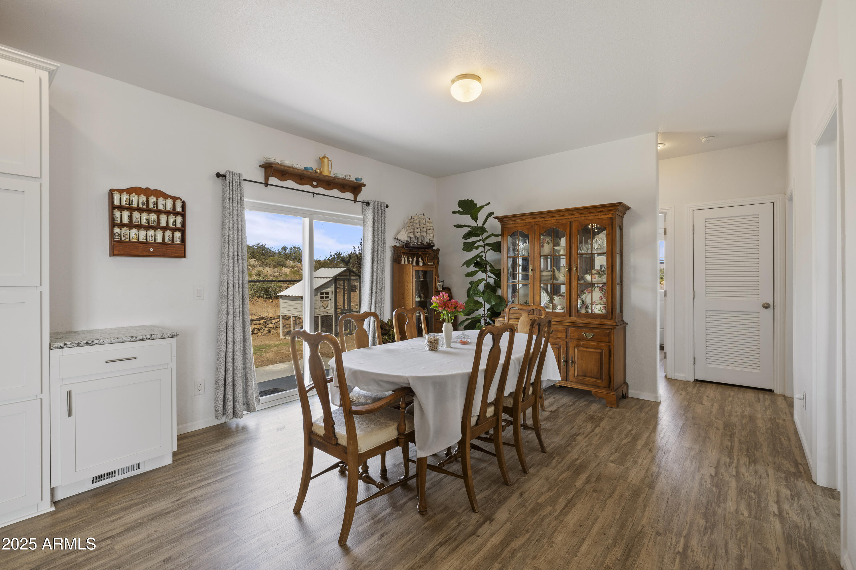 1235 North Harvest Road Dewey, AZ 86327 - Photo 8 of 37 a view of a dining room with furniture window and wooden floor
