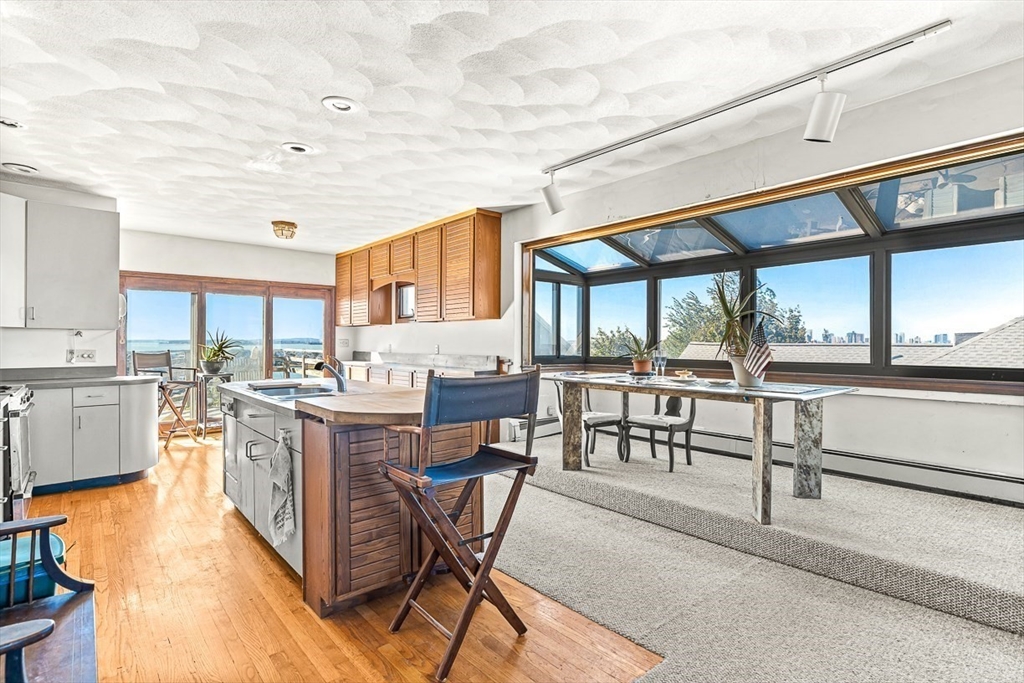 47 Prospect Avenue, Unit 47 Winthrop, MA 02152 - Photo 16 of 31 a open kitchen with stainless steel appliances granite countertop a stove and cabinets
