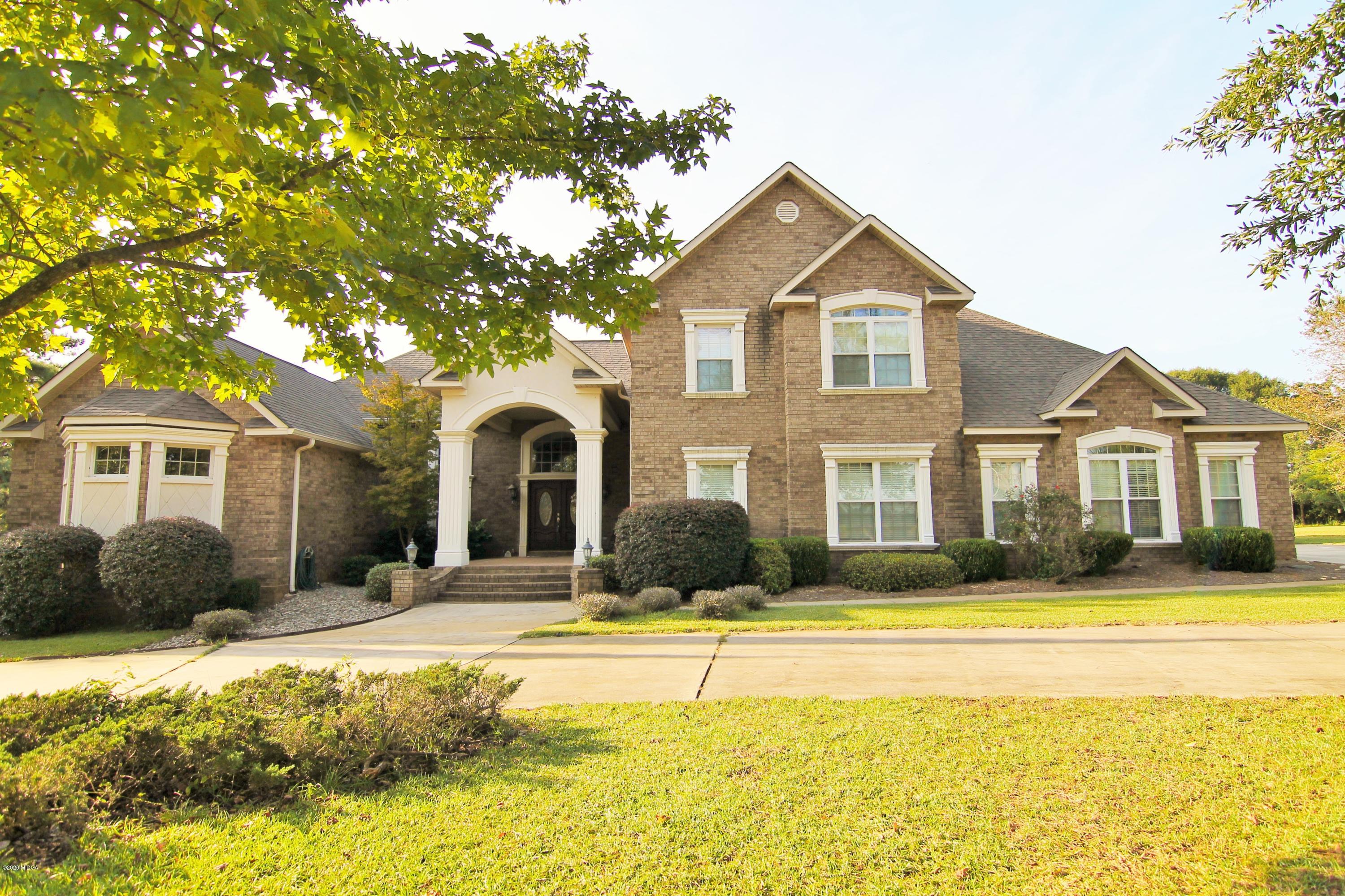 629 Toomer Road Perry, GA 31069 - Photo 1 of 59 a front view of a house with swimming pool and porch
