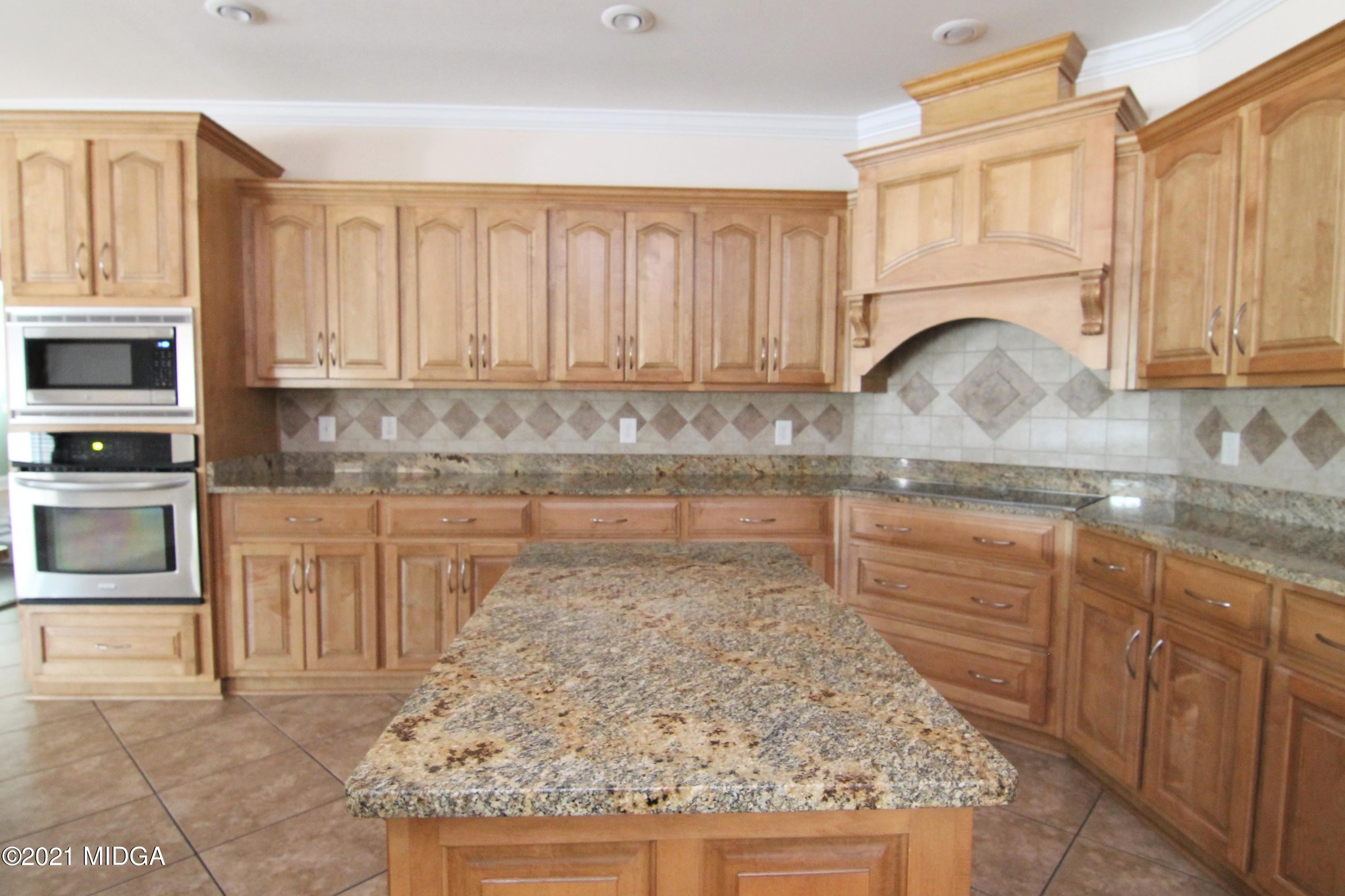 629 Toomer Road Perry, GA 31069 - Photo 11 of 59 a kitchen with granite countertop a sink a stove and cabinets