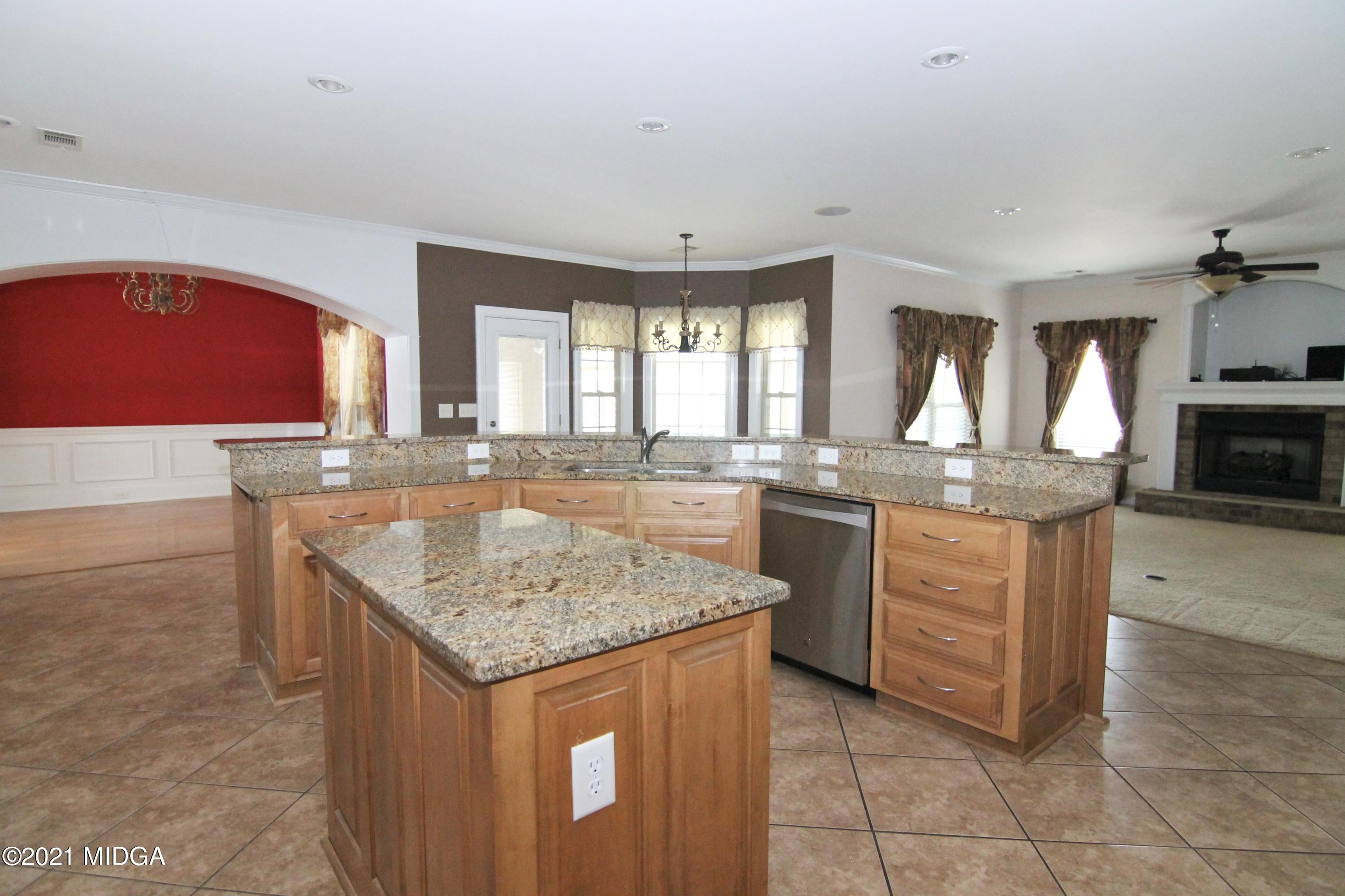 629 Toomer Road Perry, GA 31069 - Photo 13 of 59 a kitchen with granite countertop a sink stove and cabinets