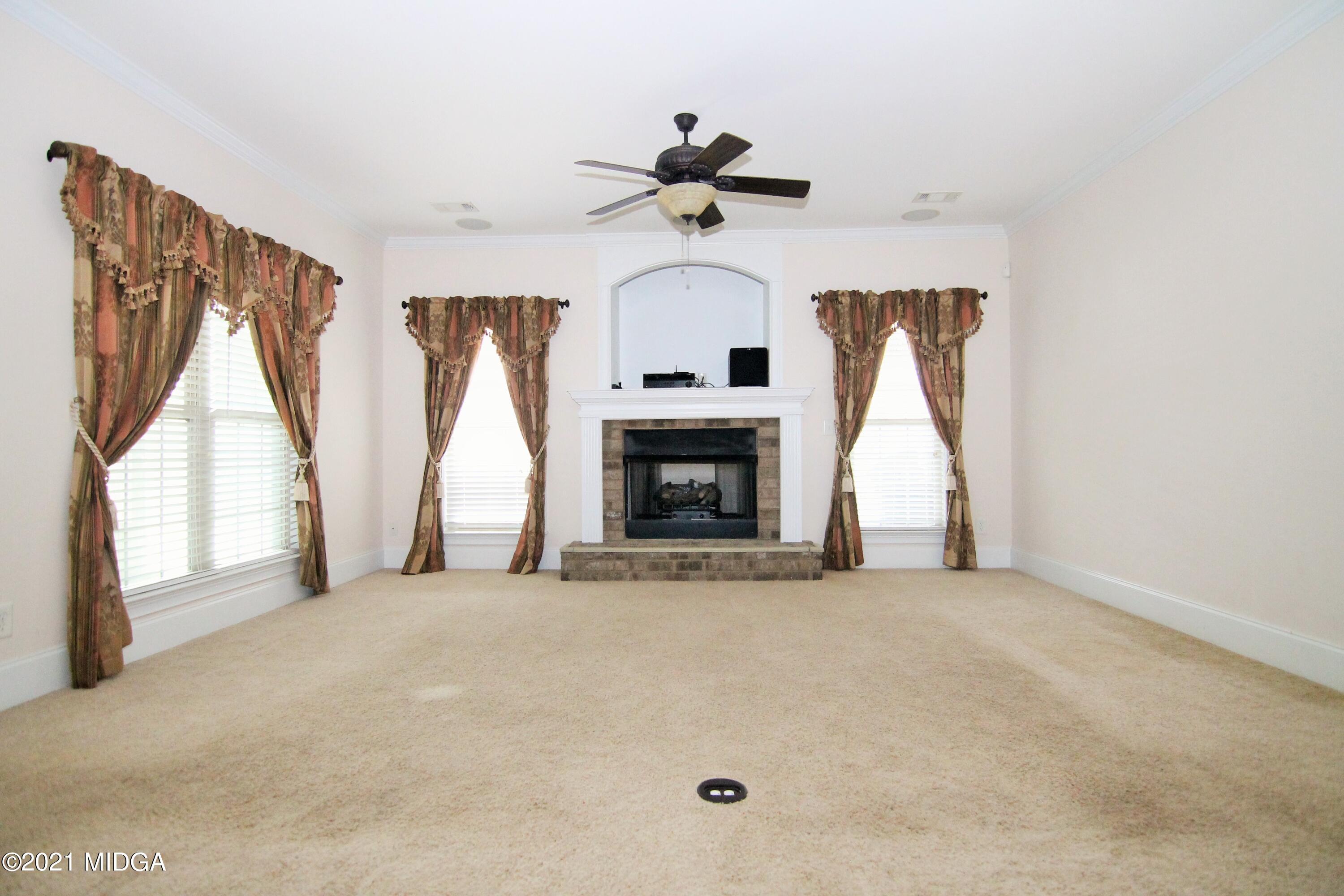 629 Toomer Road Perry, GA 31069 - Photo 14 of 59 a view of empty room with fireplace and fan