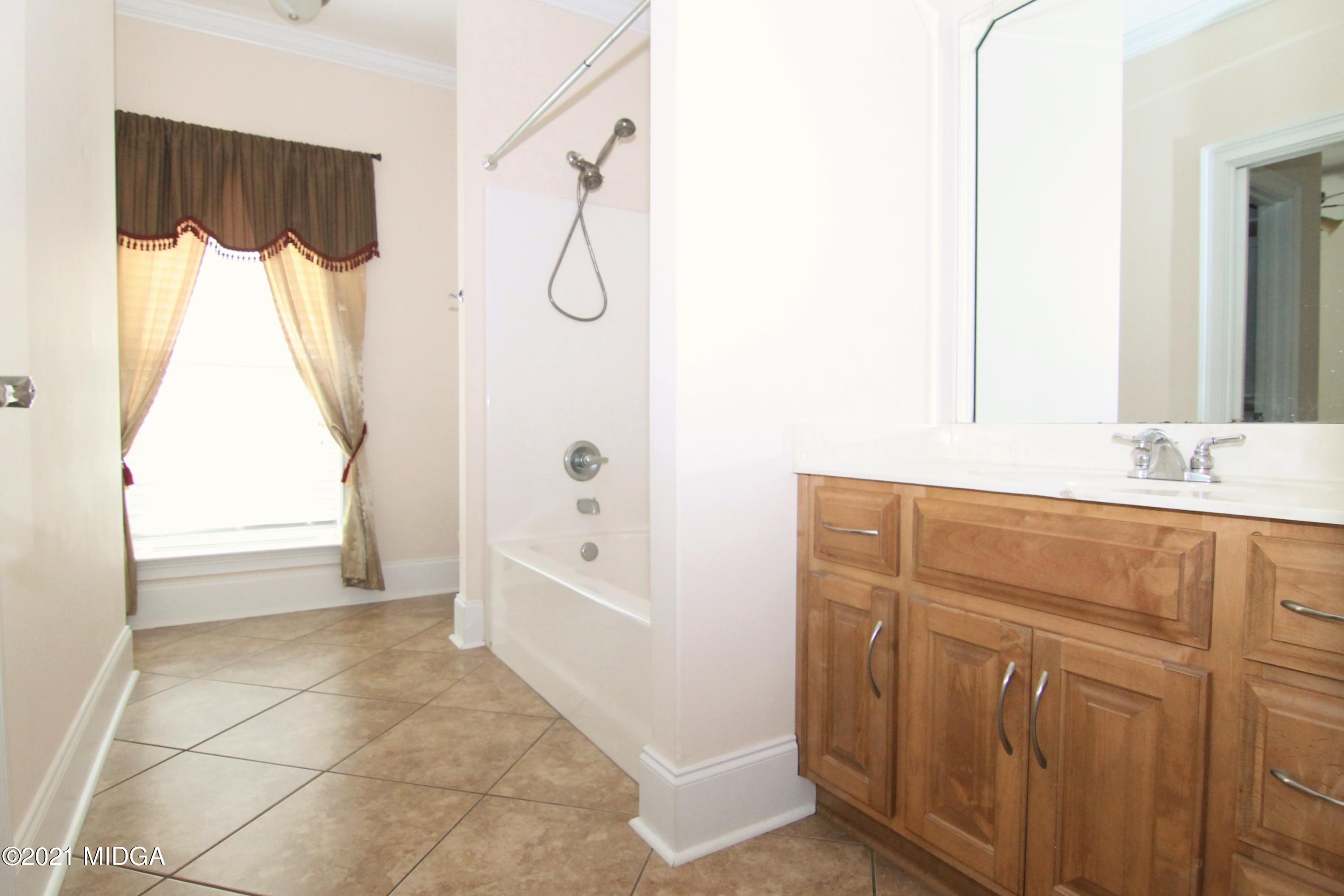 629 Toomer Road Perry, GA 31069 - Photo 28 of 59 a bathroom with a tub sink and mirror