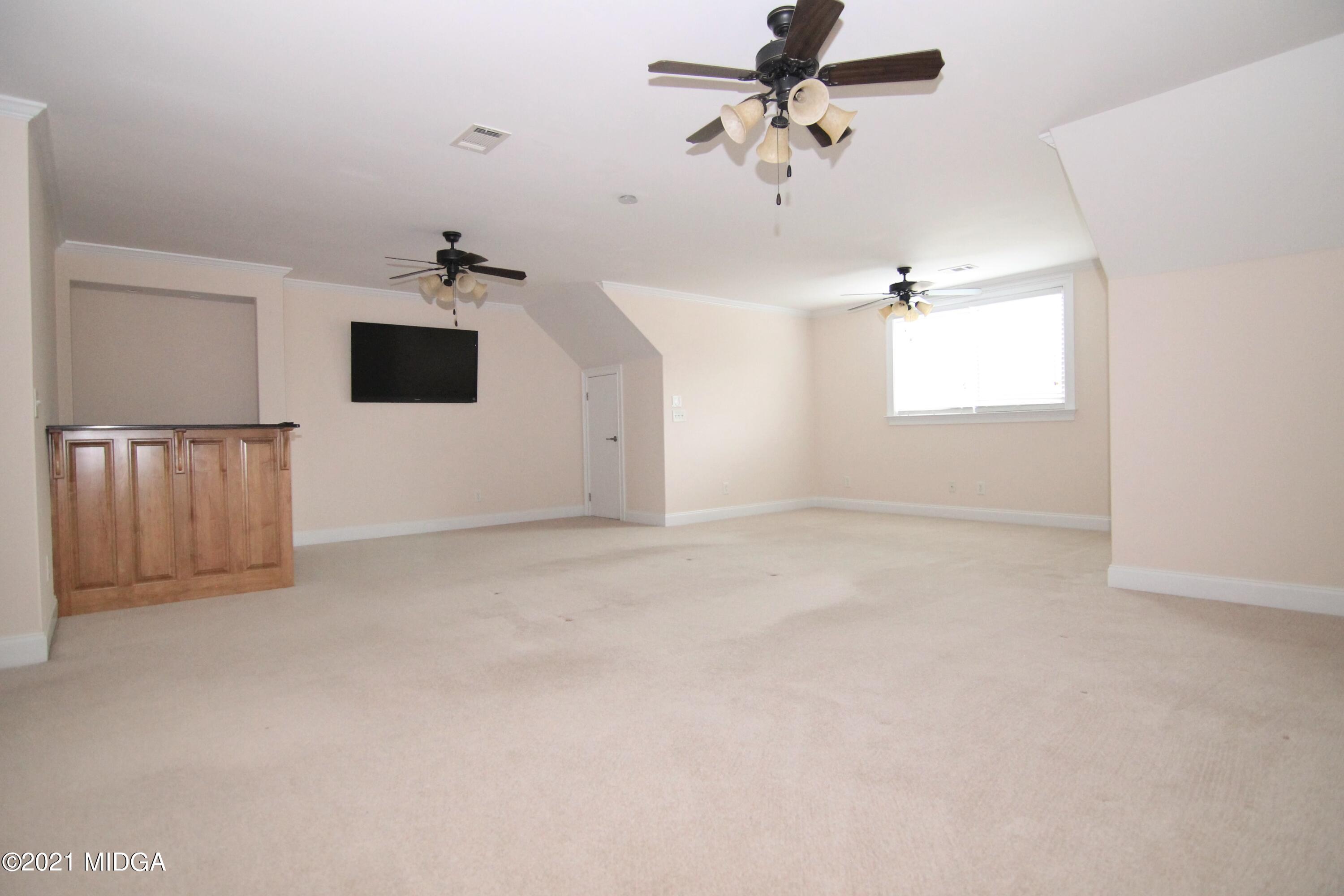 629 Toomer Road Perry, GA 31069 - Photo 32 of 59 an empty room with windows and ceiling fan