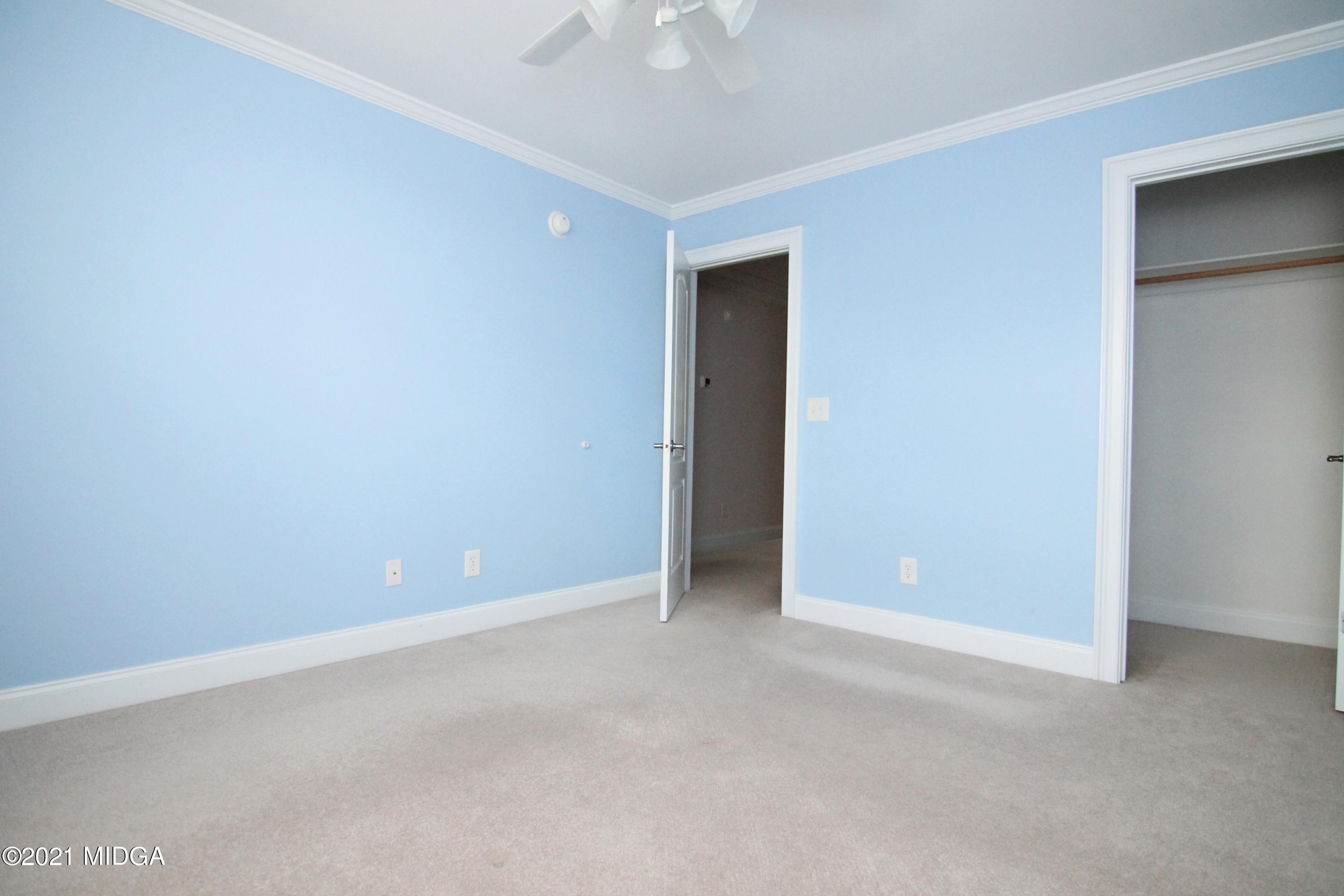 629 Toomer Road Perry, GA 31069 - Photo 37 of 59 an empty room with a ceiling fan and a window