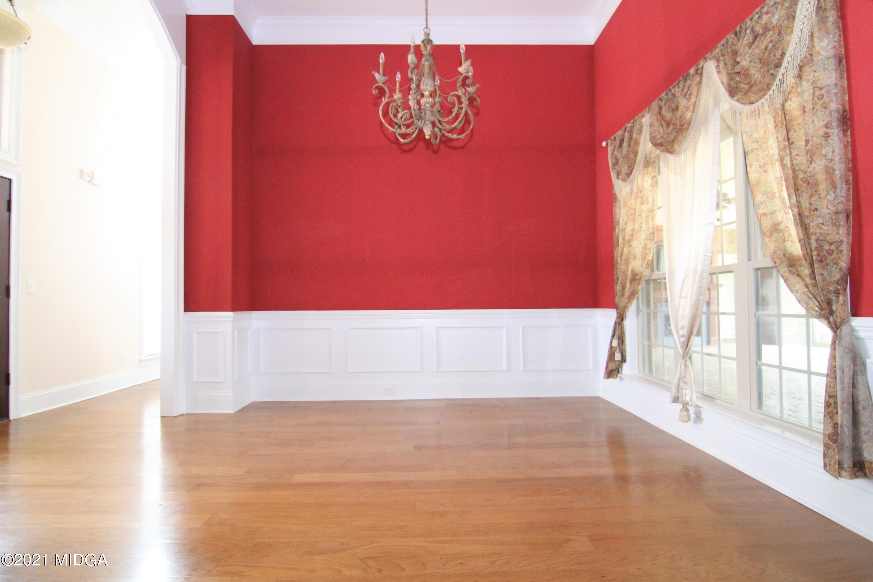 629 Toomer Road Perry, GA 31069 - Photo 5 of 59 a view of empty room with wooden floor and fan