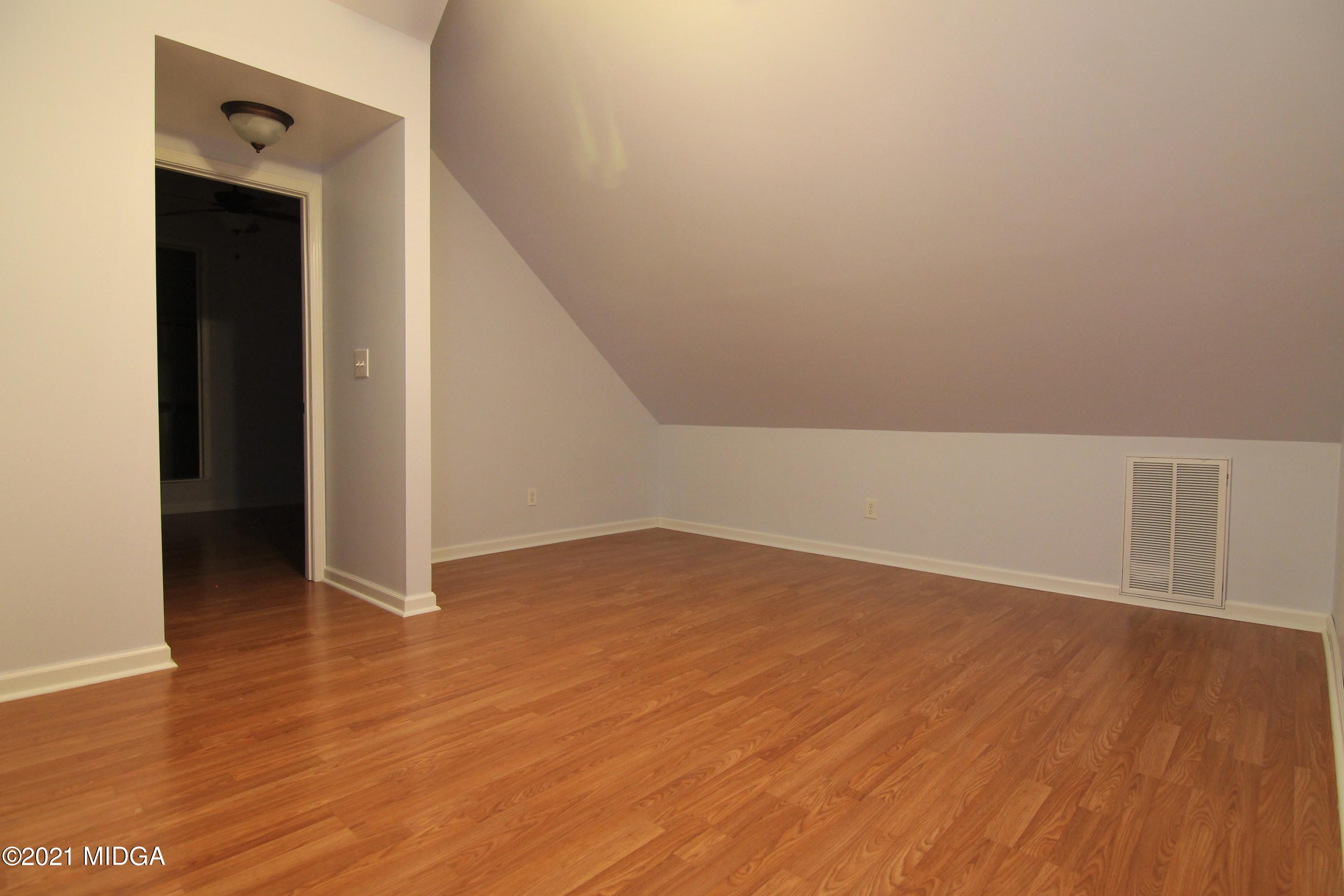 629 Toomer Road Perry, GA 31069 - Photo 45 of 59 a view of an empty room with wooden floor and closet