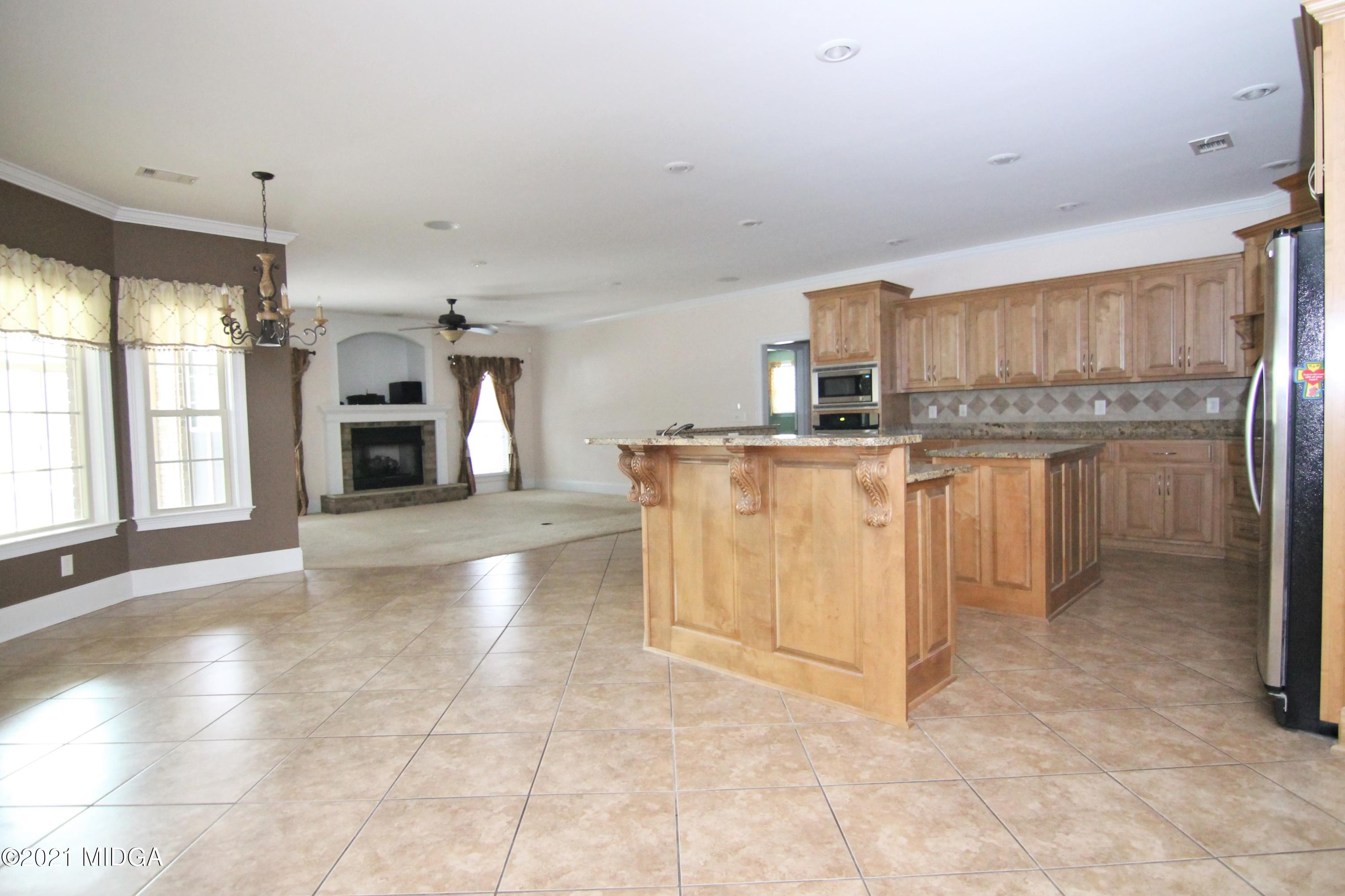629 Toomer Road Perry, GA 31069 - Photo 7 of 59 a kitchen with stainless steel appliances granite countertop a stove top oven a sink a counter space and cabinets