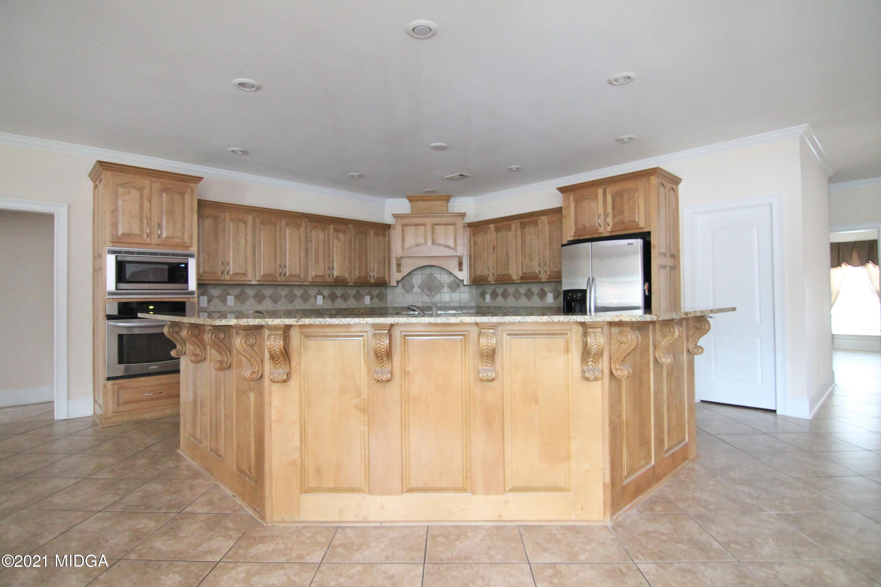 629 Toomer Road Perry, GA 31069 - Photo 8 of 59 a kitchen with stainless steel appliances granite countertop a sink and a refrigerator